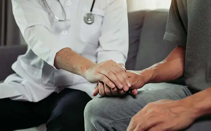 Doctor comforting patient
