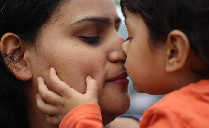 Mother and child kiss