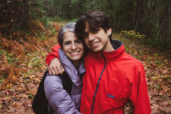 Mother and teenage son pose for picture on nature trail