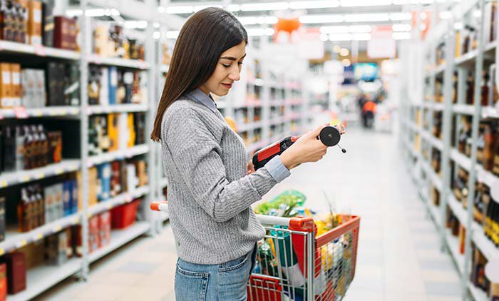 woman buying wine at supermarket