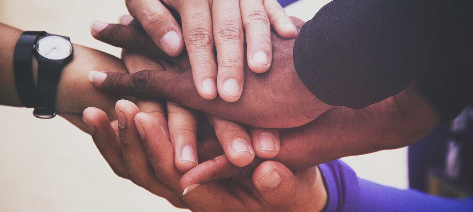 close shot of many hands together