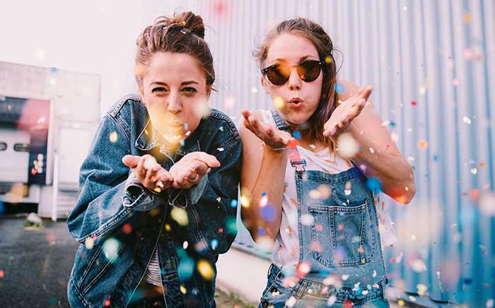 teen girls blowing sparkles