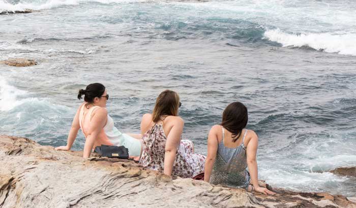 three friends talking at the shore