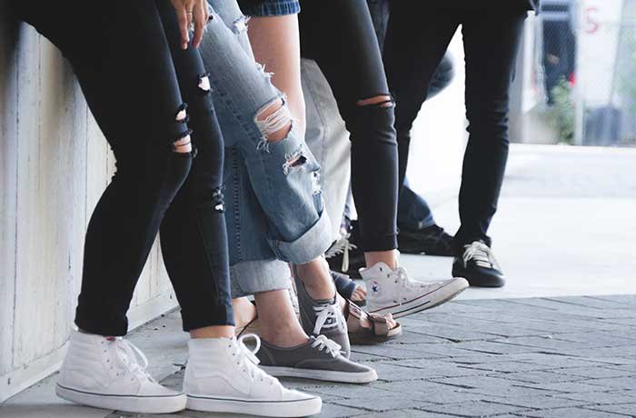 Young friends leaning on wall